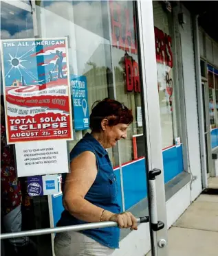  ?? STAFF PHOTO BY DOUG STRICKLAND ?? Ilaeka Villa, who owns the Grandview Mountain Cottages and Glamor Camping venue, leaves Hassler’s Drugs on Friday in Spring City, Tenn. Villa said the cottages on her property were fully booked more than a year and a half ago for the upcoming solar...