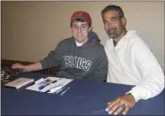  ?? PHOTO BY DAVID COTILLO ?? In this 2011 photo provided by David Cotillo, his son Chris Cotillo, left, poses with former Boston Red Sox third baseman Mike Lowell during an autograph session in Boston.