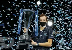  ?? FRANK AUGSTEIN — THE ASSOCIATED PRESS ?? Daniil Medvedev of Russia holds up the winners trophy as confetti falls after defeating Dominic Thiem of Austria in the final of the ATP World Finals tennis match at the ATP World Finals tournament at the O2 arena in London, Sunday.