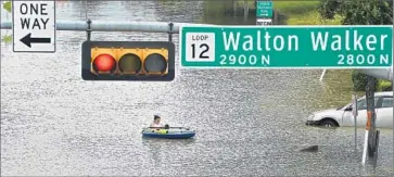  ?? Larry W. Smith
European Pressphoto Agency ?? A RAFT provides transporta­tion on a Dallas street last week. A record-setting month of rain in Texas and Oklahoma claimed hundreds of homes and at least 36 lives, but it also ended the region’s five-year drought.