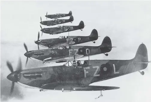  ?? (Photo courtesy of the RAF via author.) ?? 1939: An echelon of Spitfire Mk. Is flies over England.
For the war, the peacetime echelon was revised into two pairs of Spitfires that were farther apart and flew in a step-down formation so that they’d be better able to support one another during fast combat maneuvers. Each was armed with 8w Browning .30-caliber machine guns and had a top speed of 362mph. They were capable foes of early Bf 109s but were soon outclassed by more powerful versions.