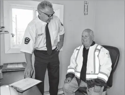  ?? SHARON MONTGOMERY-DUPE/CAPE BRETON POST ?? Greg McNeil, left, owner/director of security for SPS Security Atlantic Ltd., goes over details about the security company with Don Dickson, 74, of Sydney, during a training session Thursday after the company hired him. The Cape Breton Post recently featured a story on a humorous ad Dickson posted in the newspaper in regard to his search for employment. Dickson received about 50 emails, which included at least 15 job offers. Dickson officially starts work with the company doing security at Canadian Tire next week.