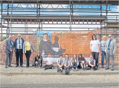  ??  ?? Officials and children by one of the banners at the launch of the abbey trail. Picture: Paul Reid.