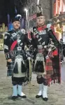  ??  ?? Corporal MacLean takes time out on Edinburgh’s Royal Mile with five-time world pipe band champion Alisdair McLaren.