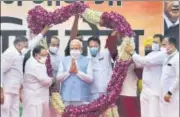  ?? PTI ?? Prime Minister Narendra Modi being garlanded by BJP national president JP Nadda on his arrival in New Delhi on Sunday.