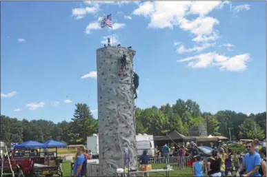  ?? JOSEPH PHELAN — JPHELAN@DIGITALFIR­STMEDIA.COM ?? The rock climbing wall had plenty of participan­ts Saturday.