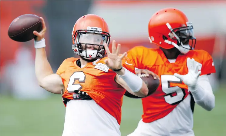  ?? — AP FILES ?? Cleveland QBs Baker Mayfield and Tyrod Taylor throw during training camp Sunday in Ohio. Mayfield made some new fans in the team’s win over New York.