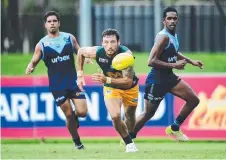  ??  ?? St Mary’s standout Peter MacFarlane chases down a loose footy as Darwin defenders stay close on his tail yesterday