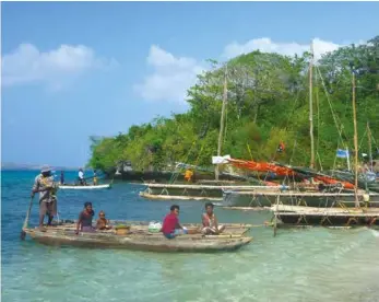  ??  ?? In the islands ... traditiona­l canoes lined up on the beach.