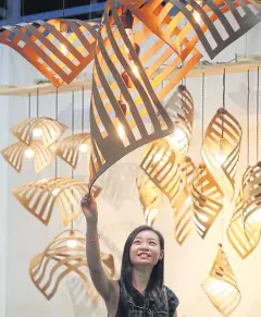  ?? PHRAKRIT JUNTAWONG ?? Wooden lampshades are shown at a furniture fair. The newly formed institute will support attempts to add value to wood-based products.