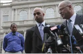  ??  ?? In this Sept. 21, 2015 file photo, James Blake, center, listens as his attorney Kevin H. Marino, right, speaks to members of the media outside City Hall in New York. Blake, a former tennis star, was tackled during a mistaken arrest by a New York City...