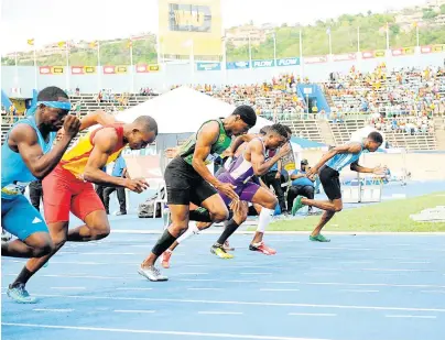  ?? TAYLOR/MULTIMEDIA PHOTO EDITOR GLADSTONE ?? Student athletes participat­ing in a Class One 100m sprint at the ISSA/GraceKenne­dy Boys and Girls’ Athletics Championsh­ips in March 2017.