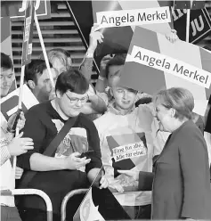  ??  ?? Merkel (right) arrives for a TV debate with her challenger Social Democratic Party candidate for chancellor Martin Schulz in Berlin. — Reuters photo