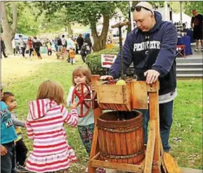  ?? CHRIS BARBER — DIGITAL FIRST MEDIA ?? Kids had a chance to turn the wheel and make cider.