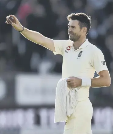  ??  ?? England record-breaker James Anderson shows off the ball with which he took his 500th Test wicket.