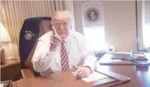  ?? — AFP ?? President Donald Trump poses in his office aboard Air Force One at Andrews Air Force Base in Maryland after he returned from Philadelph­ia on Thursday.