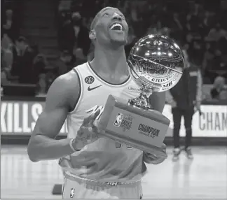  ??  ?? Bam Adebayo holds his trophy after winning the NBA Skills Challenge at the United Center on Saturday.