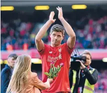  ?? Photo: GETTY IMAGES ?? Steven Gerrard applauds the Kop end as his daughter brings him flowers after his Premier League farewell to Anfield, a 3-1 loss to Crystal Palace.