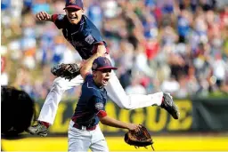  ?? Associated Press ?? Endwell, N.Y.’s Michael Mancini, bottom, and Jude Abbadessa celebrate after winning the United States championsh­ip against Goodlettsv­ille, Tenn., on Saturday at the Little League World Series in South Williamspo­rt, Pa. Endwell, N.Y., won, 4-2, and is...