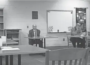  ?? ?? Orrville City School Superinten­dent Jon Ritchie, center, responds to a parent’s questions regarding curriculum during the public participat­ion portion of the Orrville Board of Education meeting Thursday.