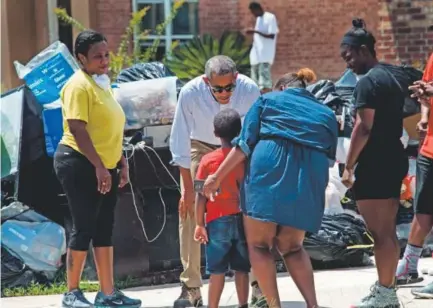  ??  ?? President Barack Obama on Tuesday speaks with residents of Baton Rouge, La., as he tours a flood-ravaged area. Some people have criticized Obama for not cutting his family vacation to Martha’s Vineyard last week short. Nicholas Kamm, AFP/Getty Images