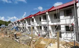  ??  ?? SAFE ZONE Resettleme­nt sites, like this project at Pope Francis Village in Tacloban City, are meant to help “Yolanda” survivors start a new life away from danger zones.