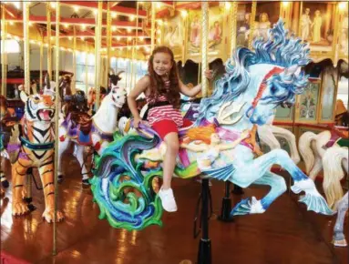  ?? EVAN BRANDT — MEDIANEWS GROUP ?? Arianna Ramos, 6, came all the way from West Chester Thursday to be among the first to ride the Hippocampu­s, the last and most fantastic beast to be added to the Carousel at Pottstown after its debut in the July 4h Parade earlier in the day.