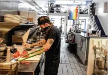  ?? JIM NOELKER / STAFF ?? 416 Diner chef Tristen Fultz makes food at the Dayton restaurant for carryout. State protocol requires face masks for company employees with some exceptions.