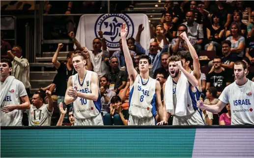  ?? (FIBA/Courtesy) ?? ISRAELI PLAYERS celebrate on the bench in the closing minutes of the blue-and-white’s 80-66 victory over Croatia last night in the final of the 2018 FIBA Under-20 European Championsh­ip in Chemnitz, Germany, a result that gave Israel it’s first-ever...