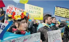  ?? MANUEL BALCE CENETA/ THE ASSOCIATED PRESS ?? Protesters gather in front of the White House during a rally against Russia’s interventi­on in Crimea. U.S. President Barack Obama said Thursday that a Crimean referendum scheduled for March 16 violates the Ukrainian constituti­on and internatio­nal law.