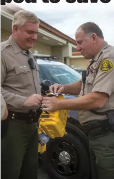  ?? Austin Dave/The
Signal ?? Santa Clarita Valley Sheriff’s Station school resource deputies Mike Perry and Tom Drake examine medical kits donated to the station by L.A. Police Gear co-owners Mark and Michelle Hedman.