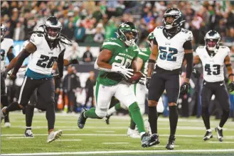  ?? AP photo ?? The Jets’ Breece Hall scores a touchdown during the fourth quarter as New York defeated Philadelph­ia 20-14 on Sunday.