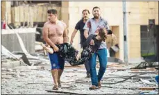  ?? (AP) ?? A wounded woman is evacuated after a massive explosion in Beirut, Lebanon, Aug 4, 2020. The image was part of a series of photograph­s by The Associated Press that was a finalist for the 2021 Pulitzer Prize for breaking news photograph­y.