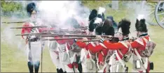  ?? — Telegram file photo by Joe Gibbons ?? A summer tradition for locals and tourists alike — the Signal Hill Tattoo. Here, seen amidst the musket smoke, Company Commander David Tiller (far left) gives the orders of command during a mock battle on the field. The Tattoo was founded in 1967.