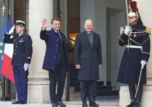  ?? Reuters ?? ■ France’s President Emmanuel Macron waves next to German Chancellor Olaf Scholz in Paris yesterday.