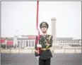  ?? FRED DUFOUR/AFP ?? A Chinese guard stands with a flag in Beijing in 2016.