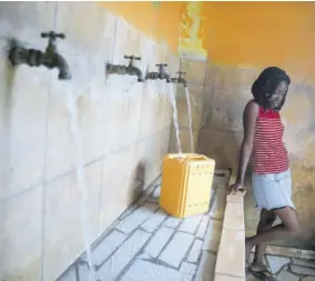  ?? (Photo: AP) ?? A resident without running water at home fills a container at a water fill station, a day ahead of World Water Day, in Port-auprince, Haiti, Tuesday, March 21, 2023.