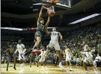  ?? THOMAS BOYD — THE ASSOCIATED PRESS ?? Baylor guard Kendall Brown (2) dunks against Oregon guard Jacob Young (42) in the second half of Saturday’s game in Eugene, Ore.