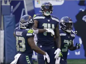  ?? ELAINE THOMPSON - THE ASSOCIATED PRESS ?? Seattle Seahawks wide receiver DK Metcalf (14) celebrates with teammates David Moore, left, and DeeJay Dallas, right, after Metcalf scored a touchdown against the San Francisco 49ers during the first half of an NFL football game, Sunday, Nov. 1, 2020, in Seattle.