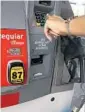  ?? CARLINE JEAN/ STAFF PHOTOGRAPH­ER ?? A woman pumps gas at a Chevron station.