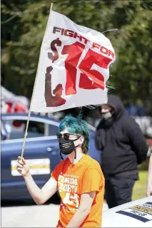  ?? JOHN RAOUX — THE ASSOCIATED PRESS ?? Cristian Cardona, an employee at a McDonald’s, attends a rally for a $15an hour minimum wage Tuesday in Orlando, Fla.