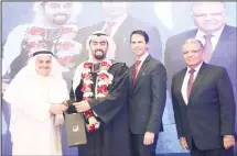  ??  ?? AAW Chairman and CEO Faisal Ali Al Mutawa and Dean of Faculty of
Pharmacy Professor Pierre Moreau handing certificat­es to graduates.