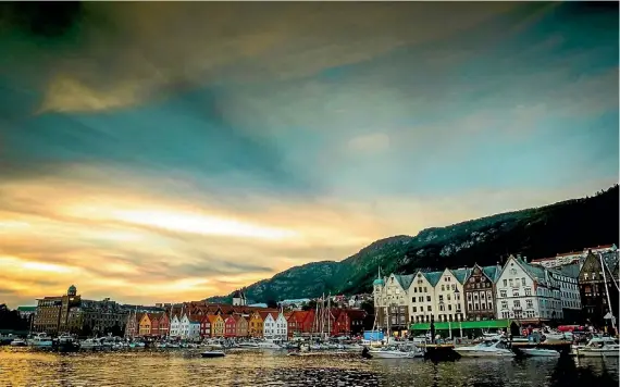  ?? PHOTOGRAPH­ER: MIKE MULCAHY ?? ‘‘I took this photo in Bergen, Norway. It’s a beautiful town but the weather was against us the whole time we were there. However, on the last night of our trip, the clouds cleared just enough for me to capture this sunset over the traditiona­l wooden...