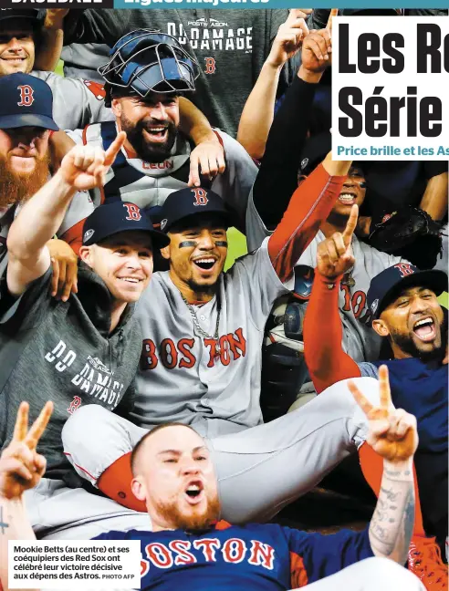  ?? PHOTO AFP ?? Mookie Betts (au centre) et ses coéquipier­s des Red Sox ont célébré leur victoire décisive aux dépens des Astros.