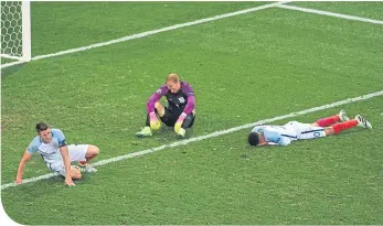  ??  ?? . . . and agony. Alli on the turf with Gary Cahill and Joe Hart after the Iceland defeat