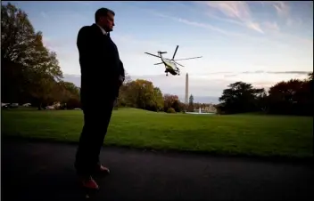  ?? ASSOCIATED PRESS ?? In this Nov. 14 file photo, a U.S. Secret Service special agent stands as Marine One, with President Donald Trump aboard, lifts off from the South Lawn of the White House in Washington.