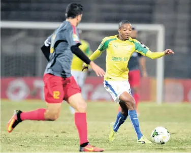  ??  ?? Thapelo Monare of Mamelodi Sundowns is challenged by Khalil Chamam of Esperance during their CAF Champions League match at the Lucas Moripe Stadium in Pretoria last night.