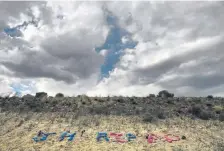  ??  ?? A memorial is displayed along a hill leading into the Ute Mountain Ute tribe reservatio­n for Jeit Redrock Height, 15, and Andrew William Cuch Jr., 14, in Towaoc in June.