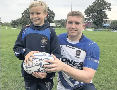 ??  ?? ●● The Match Mascot for the recent MRUFC match against Hull Ionians was Morgan Davies from the club’s under 11s, pictured with team captain Ryan Parkinson