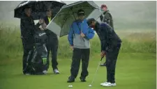  ?? GETT IMAGES ?? DEDICATION: Tiger Woods, who tees off at 10:10 today, practices yesterday in the rain at Royal Portrush.